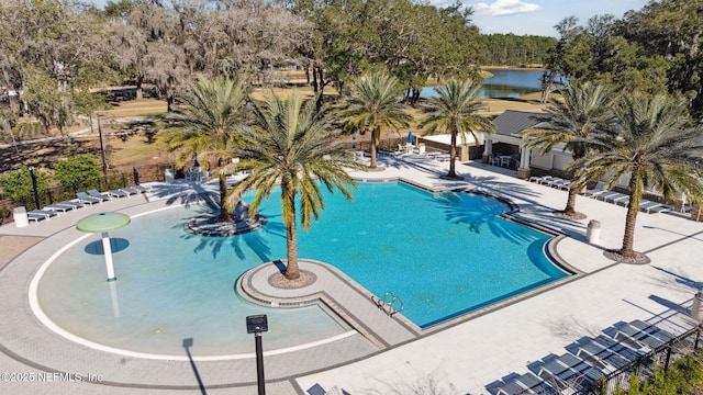 view of swimming pool with a water view and a patio area