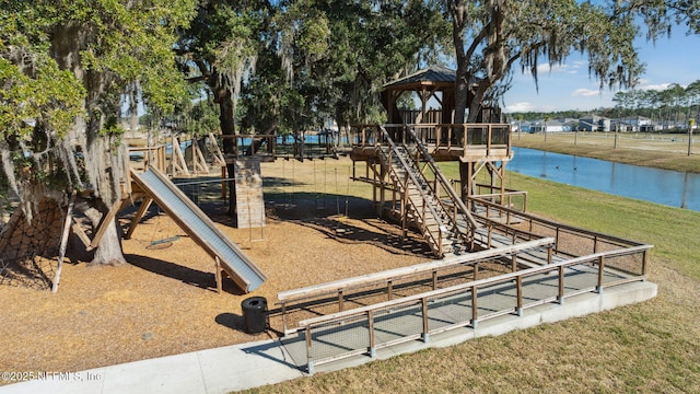 view of play area featuring a water view and a lawn