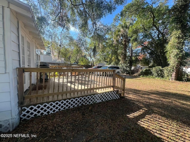 wooden terrace featuring a grill