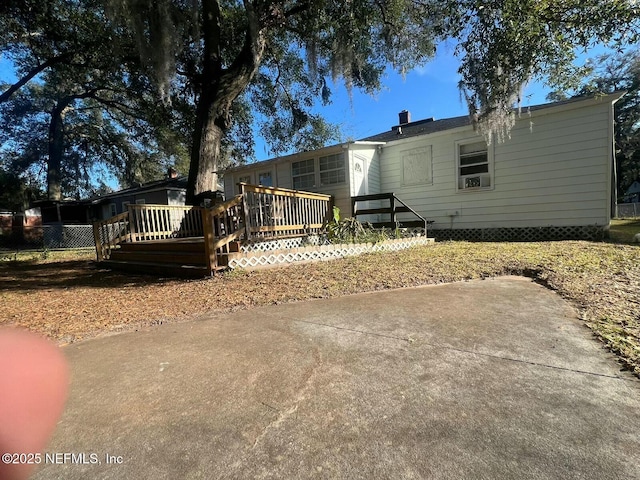 back of house with a wooden deck