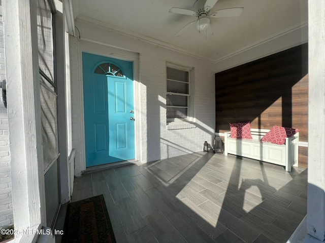 view of exterior entry featuring ceiling fan and covered porch