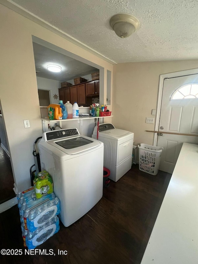 washroom featuring separate washer and dryer, a textured ceiling, and dark hardwood / wood-style flooring