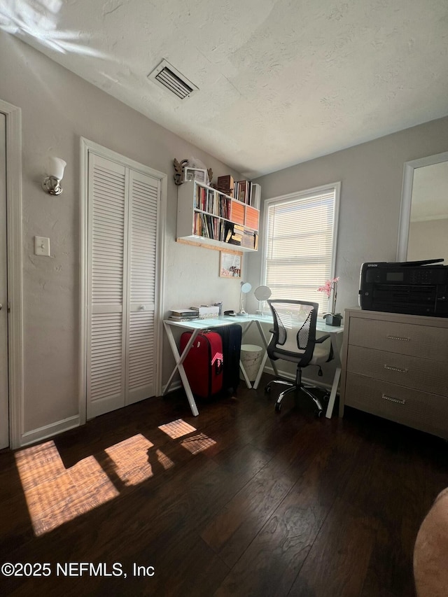 office space with a textured ceiling and dark hardwood / wood-style flooring