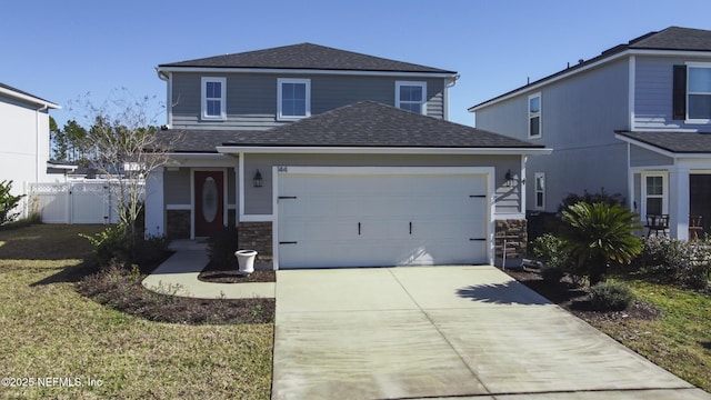 view of front property featuring a garage and a front yard