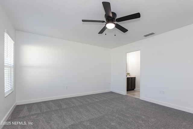 carpeted empty room featuring ceiling fan