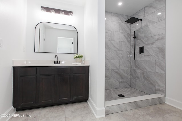 bathroom with vanity and a tile shower