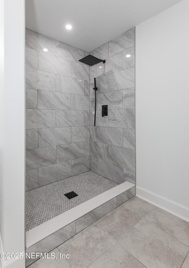 bathroom with a tile shower