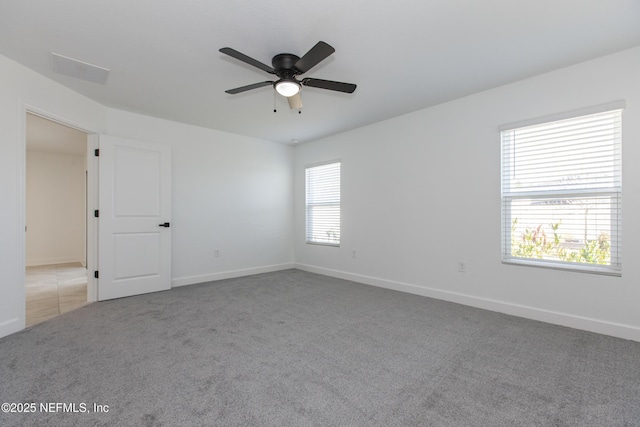 carpeted empty room featuring ceiling fan