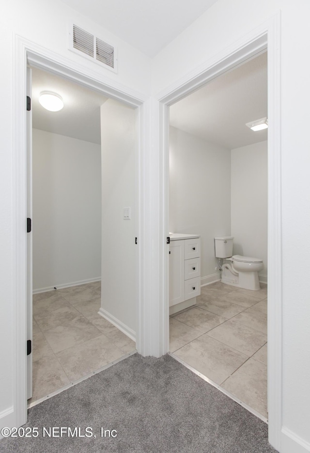 bathroom featuring tile patterned flooring and toilet