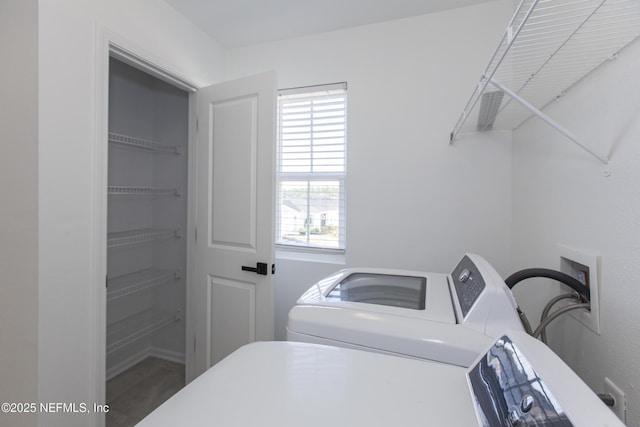 clothes washing area featuring independent washer and dryer