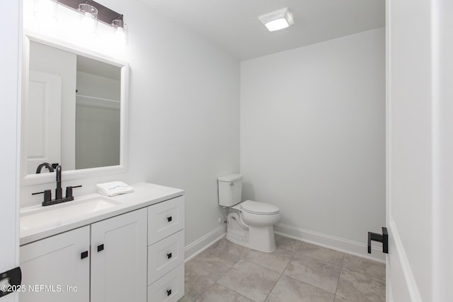 bathroom with vanity, tile patterned flooring, and toilet