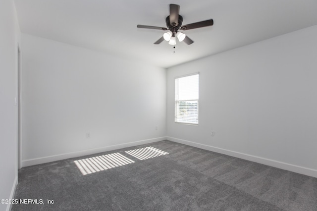 unfurnished room with ceiling fan and dark carpet