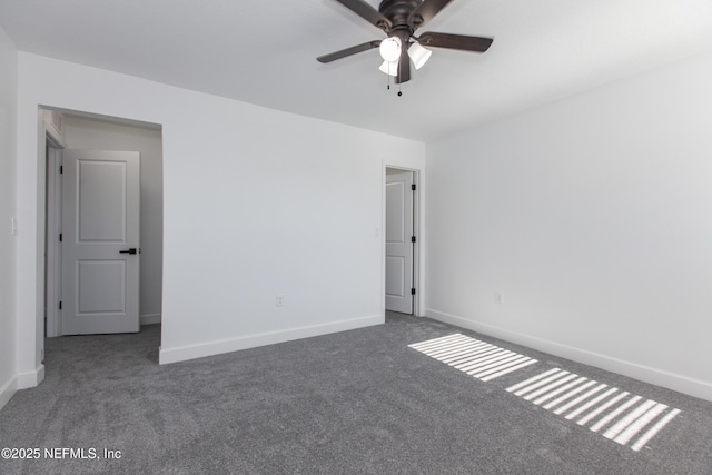 empty room with ceiling fan and dark colored carpet