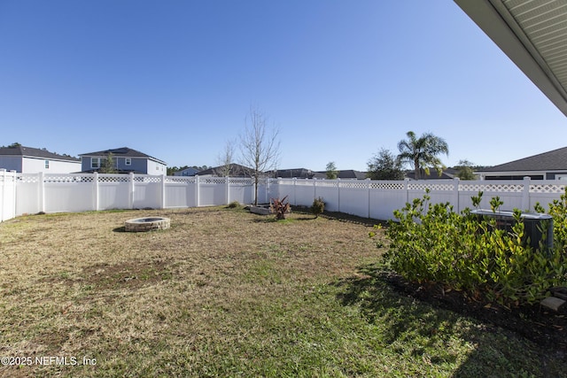 view of yard with a fire pit