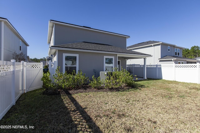 back of property featuring a lawn