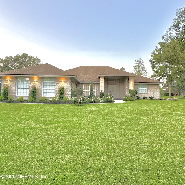 ranch-style home with a front lawn