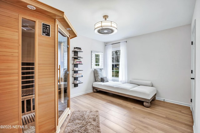 bedroom with light hardwood / wood-style floors and a closet