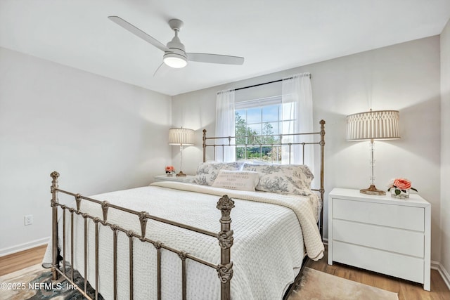 bedroom with ceiling fan and light wood-type flooring