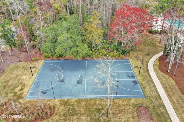 view of sport court featuring a lawn