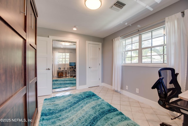 home office with light tile patterned floors