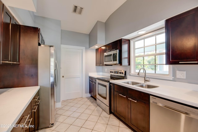 kitchen featuring stainless steel appliances, light tile patterned flooring, and sink