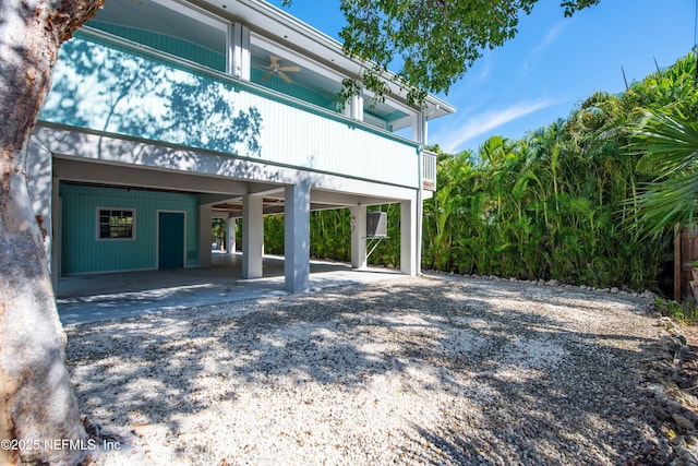 exterior space featuring ceiling fan and a carport