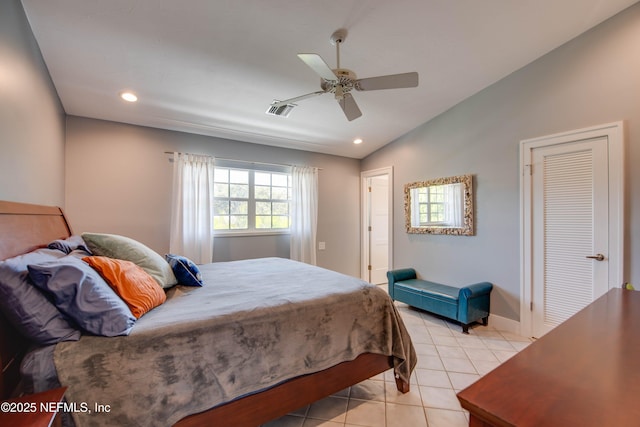 tiled bedroom featuring vaulted ceiling and ceiling fan