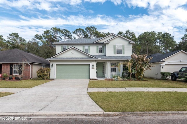 view of property featuring a garage and a front yard