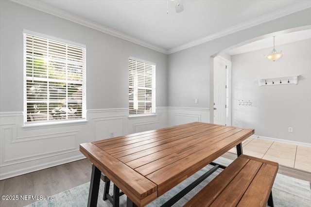 dining area featuring ornamental molding and light hardwood / wood-style floors