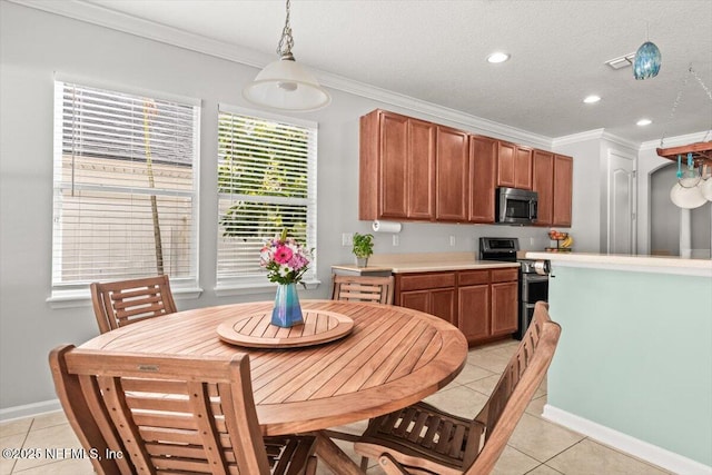 kitchen with pendant lighting, light tile patterned floors, appliances with stainless steel finishes, ornamental molding, and a textured ceiling