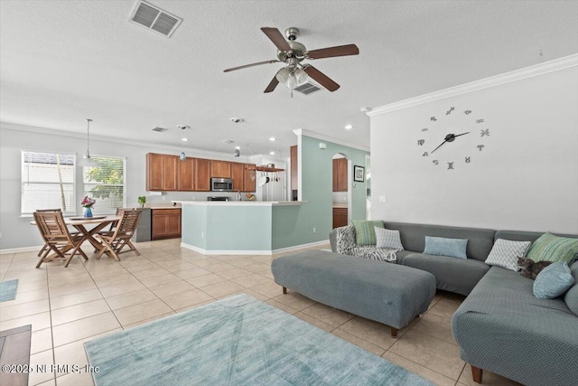 living room with light tile patterned floors, crown molding, a textured ceiling, and ceiling fan