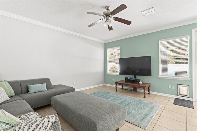 tiled living room with ceiling fan, a healthy amount of sunlight, ornamental molding, and a textured ceiling