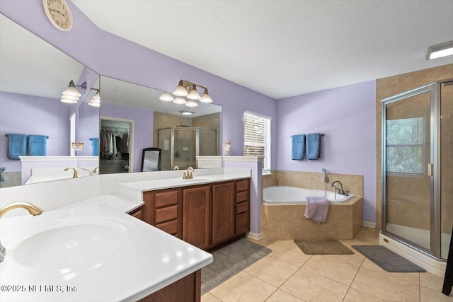 bathroom featuring vanity, tile patterned floors, plus walk in shower, and a textured ceiling