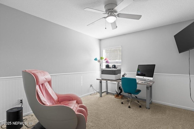 home office with ceiling fan, carpet floors, and a textured ceiling