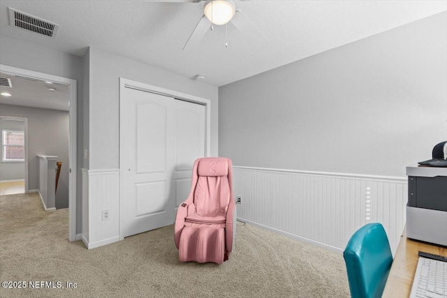 interior space featuring light colored carpet and a textured ceiling