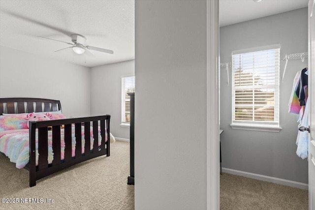 bedroom featuring light carpet and ceiling fan