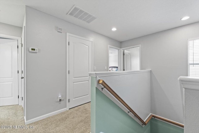 hallway featuring light carpet