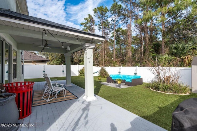 deck featuring a yard, an outdoor hangout area, and ceiling fan