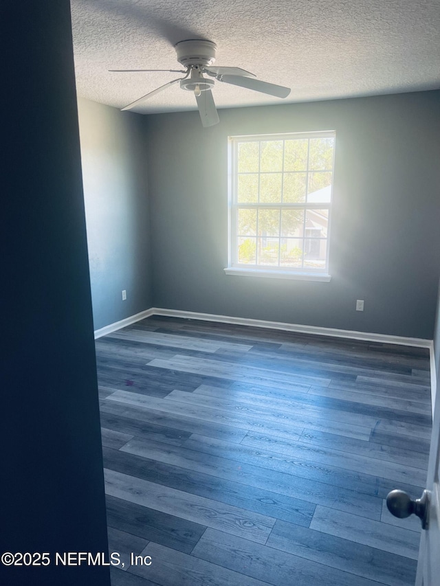 unfurnished room featuring ceiling fan, wood-type flooring, and a textured ceiling