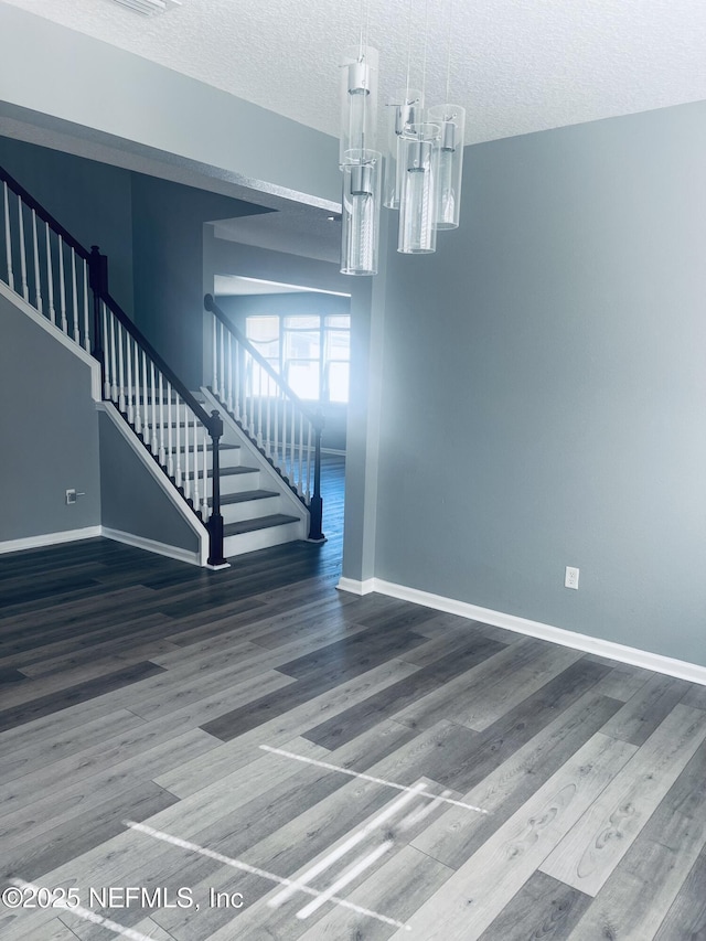 interior space featuring hardwood / wood-style floors and a textured ceiling