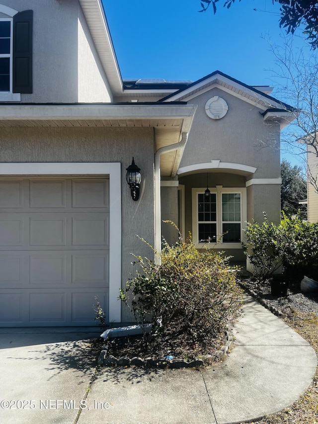 view of exterior entry with a garage