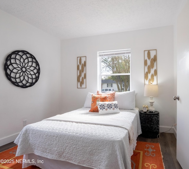 bedroom featuring dark hardwood / wood-style floors and a textured ceiling