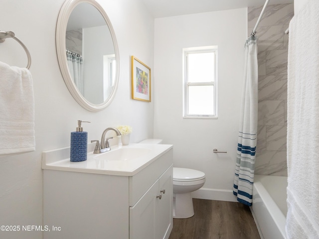 full bathroom with hardwood / wood-style flooring, vanity, toilet, and shower / tub combo