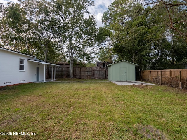 view of yard featuring a storage unit and a patio