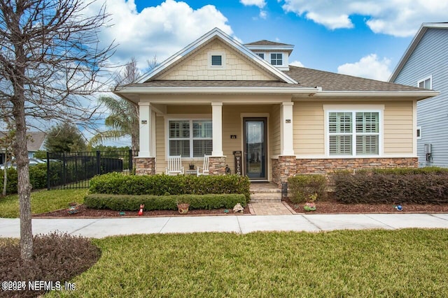 craftsman-style home with a porch and a front lawn