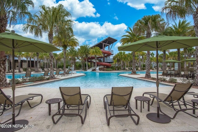 view of pool featuring a patio and a water slide