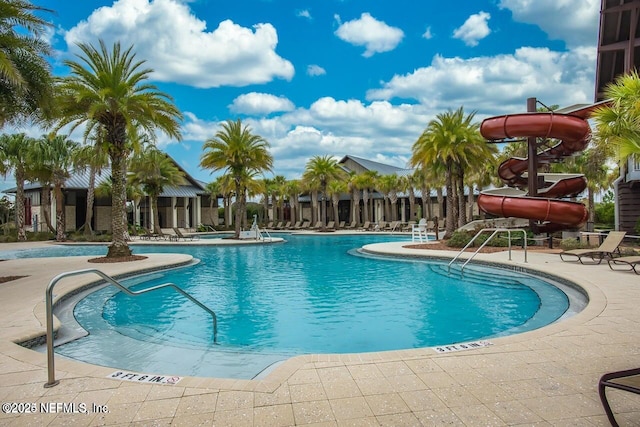 view of swimming pool featuring a patio and a water slide