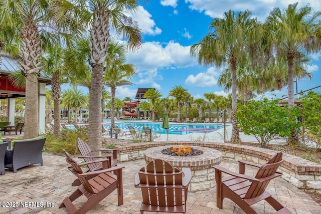 view of patio featuring a community pool and a fire pit