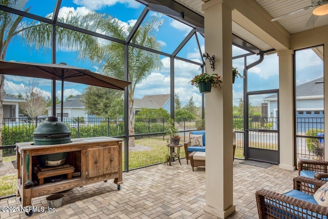 sunroom / solarium featuring a wealth of natural light and ceiling fan