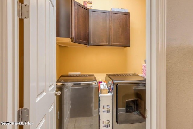 laundry area featuring cabinets and washing machine and clothes dryer